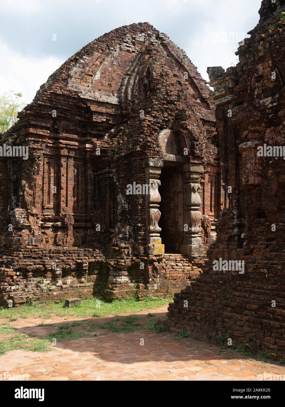 The front of an ancient Champa Hindu Temple with carvings around entrance and a domed roof. Stock Photo