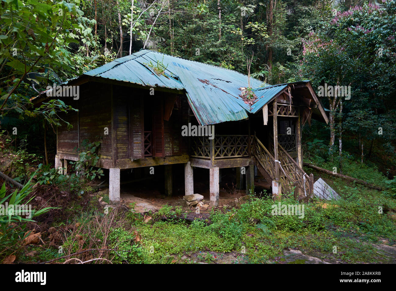 Looking at an abandoned, rotting cottage near the waterfall at Gunung Stong State park. In DaBong, Kelantan, Malaysia. Stock Photo