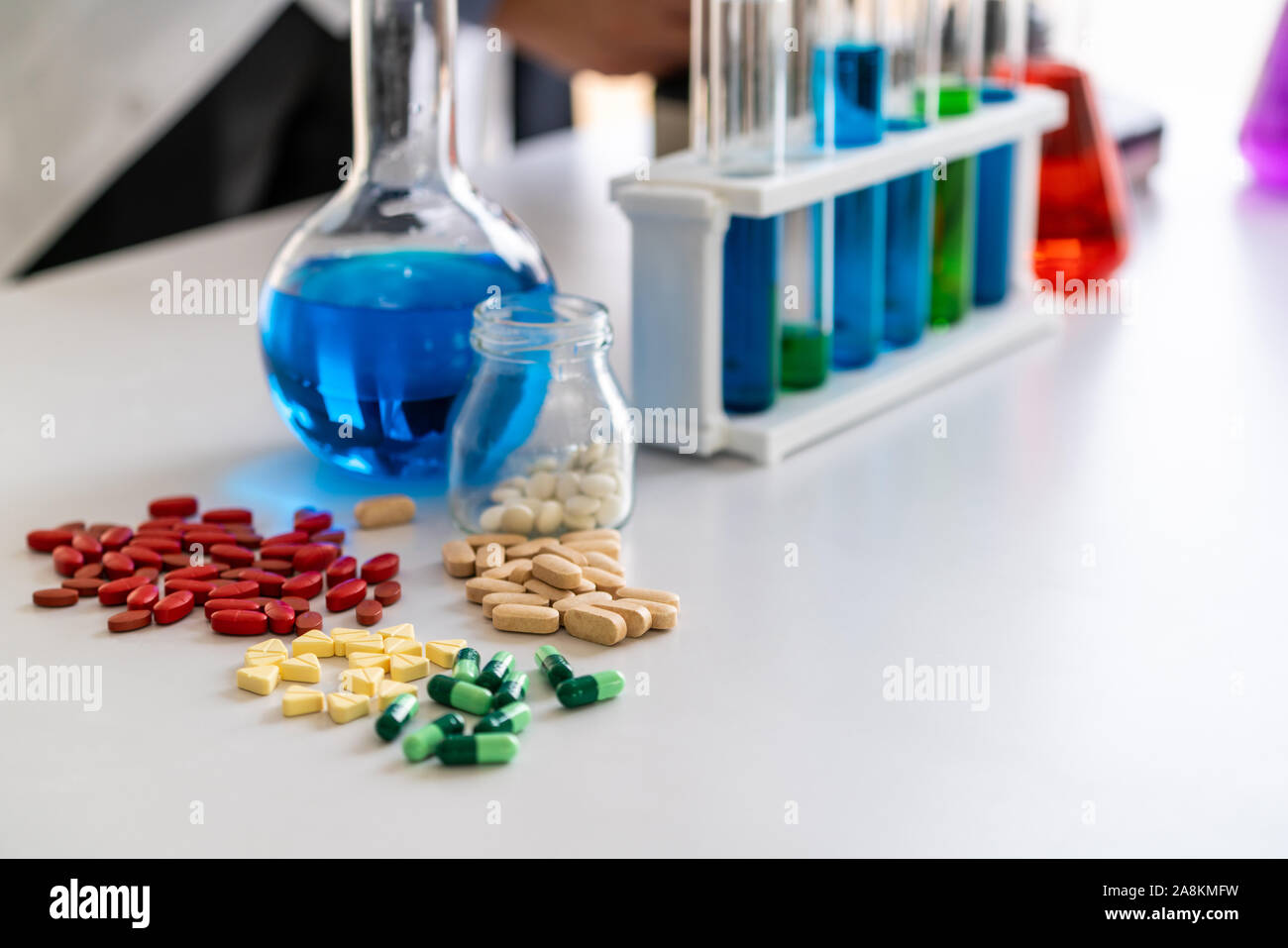 Colorful medicine pills and tablets in pharmaceutical lab. Concept of