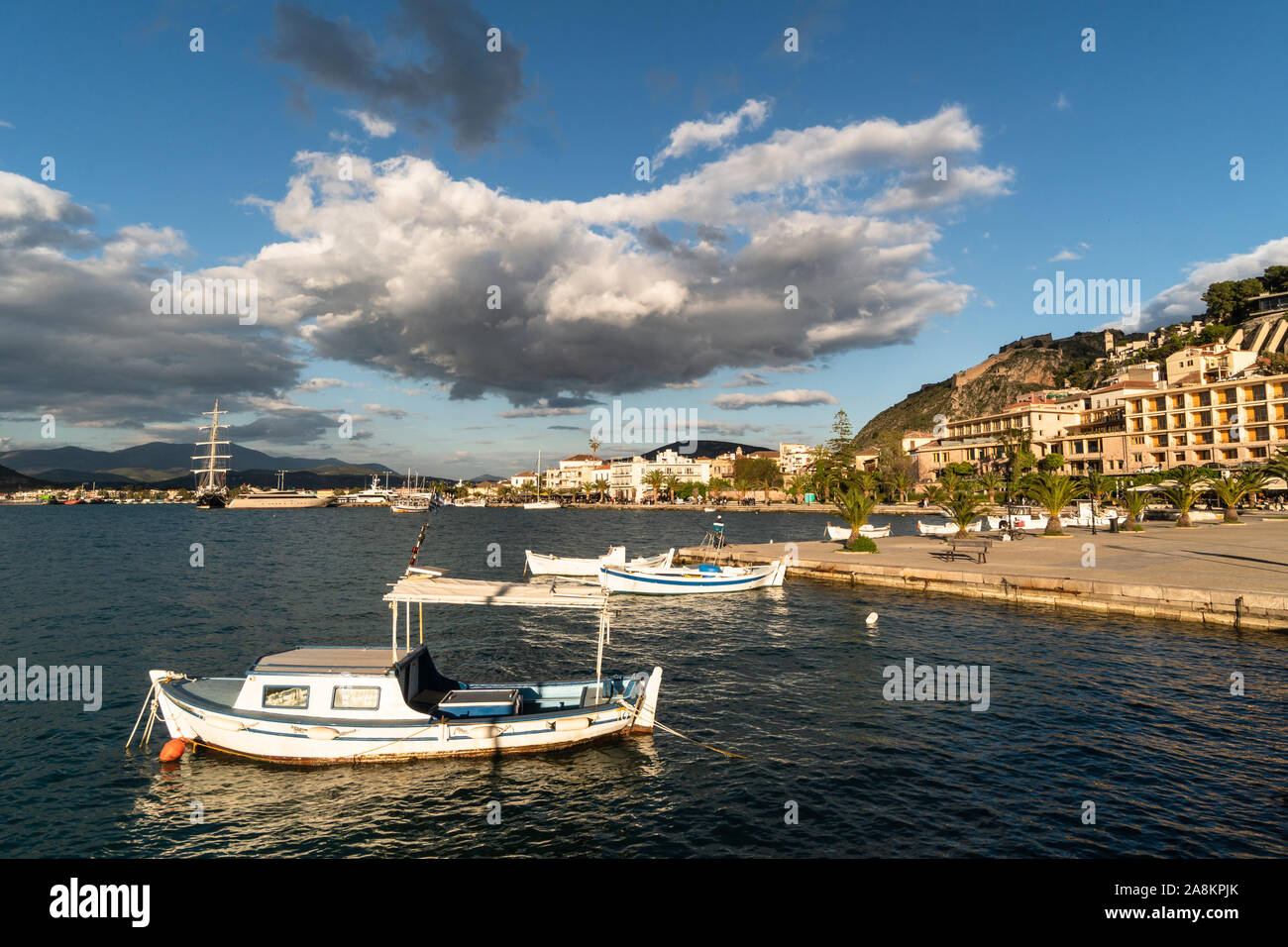Late afternoon light on the Nafplion waterfront promenade and harbor in the Peloponnese in Greece Stock Photo