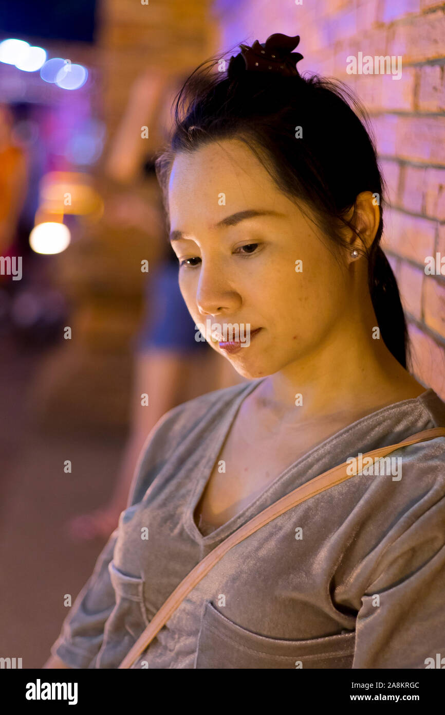 Portrait of Asian woman holding a traditional paper lantern during Yi peng (or Yee peng) festival in Thapae Gate Chiangmai Stock Photo