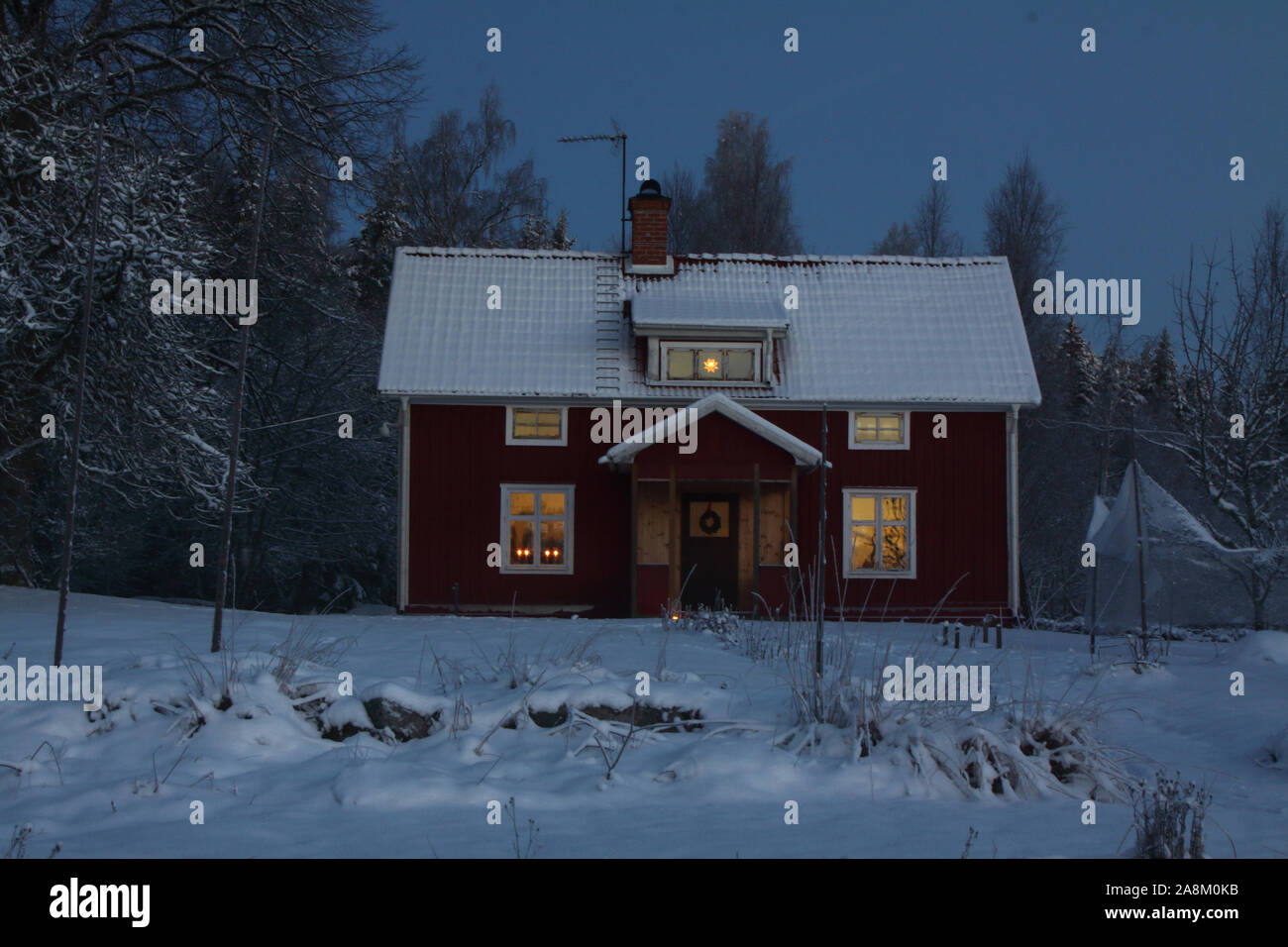 Wooden house during winter night and dark blue sky in Sweden, Arboga. Stock Photo
