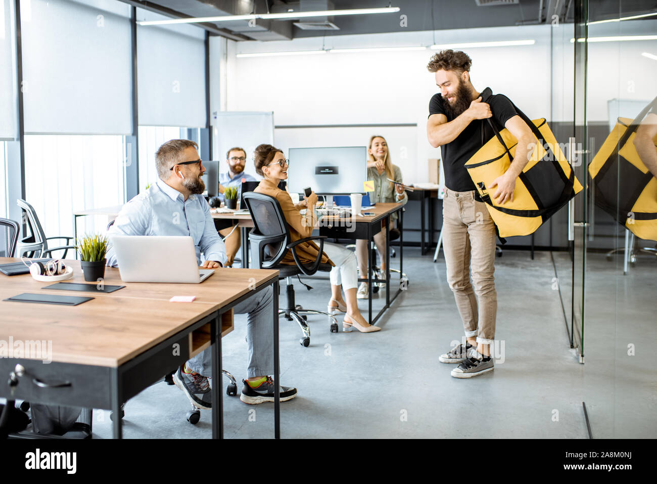 Courier delivering fresh lunches with thermal bag for an office workers