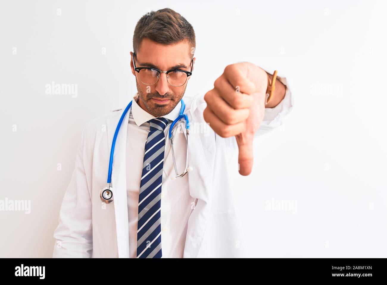 Young handsome doctor man wearing stethoscope over isolated background ...
