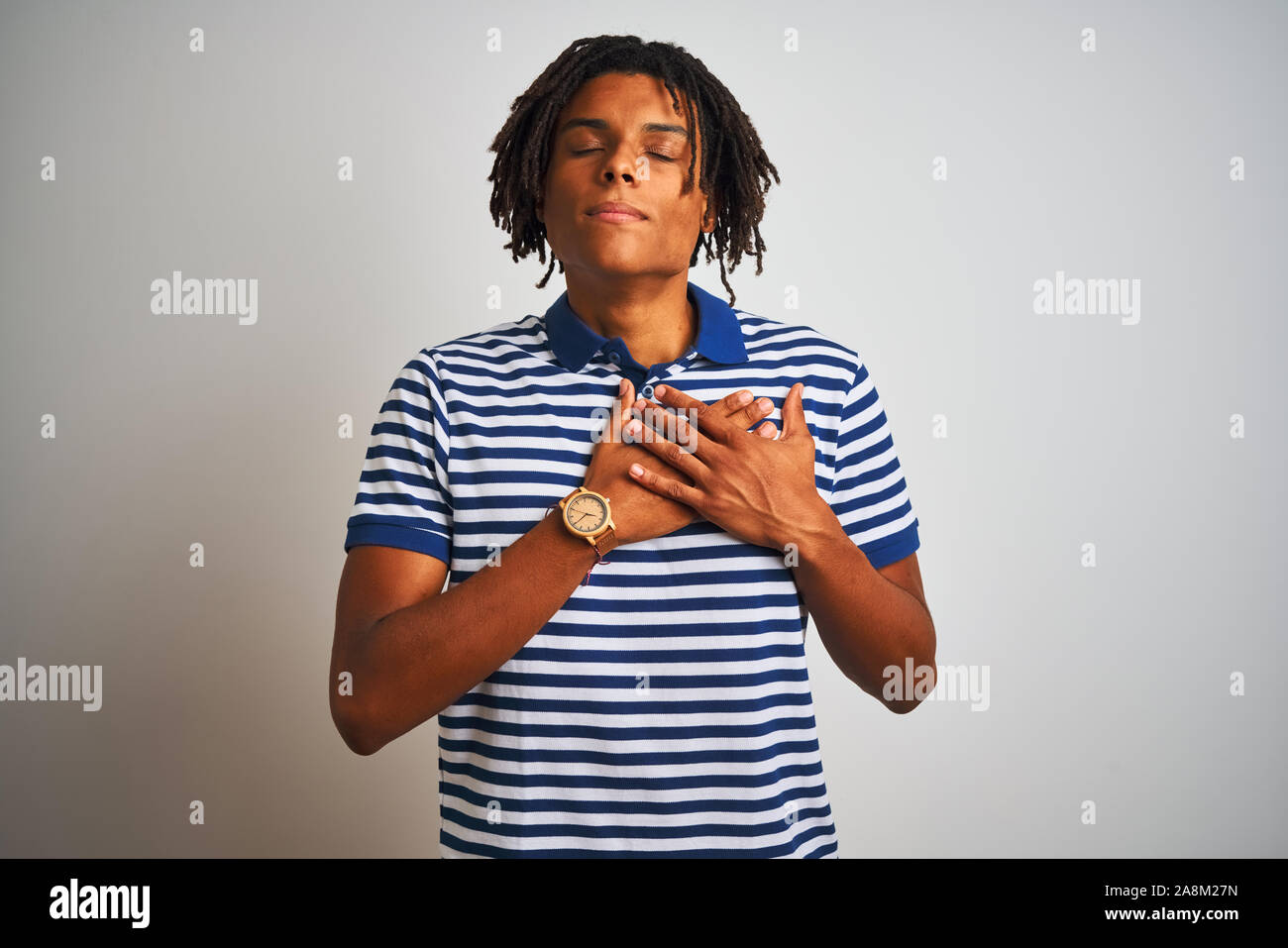 Dreadlocks Chest Afro man with dreadlocks wearing striped blue polo standing over ...