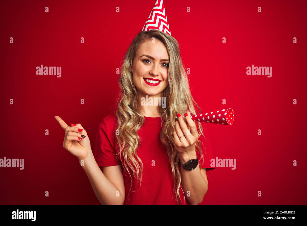 Young beautiful woman on birthday celebration over red isolated ...