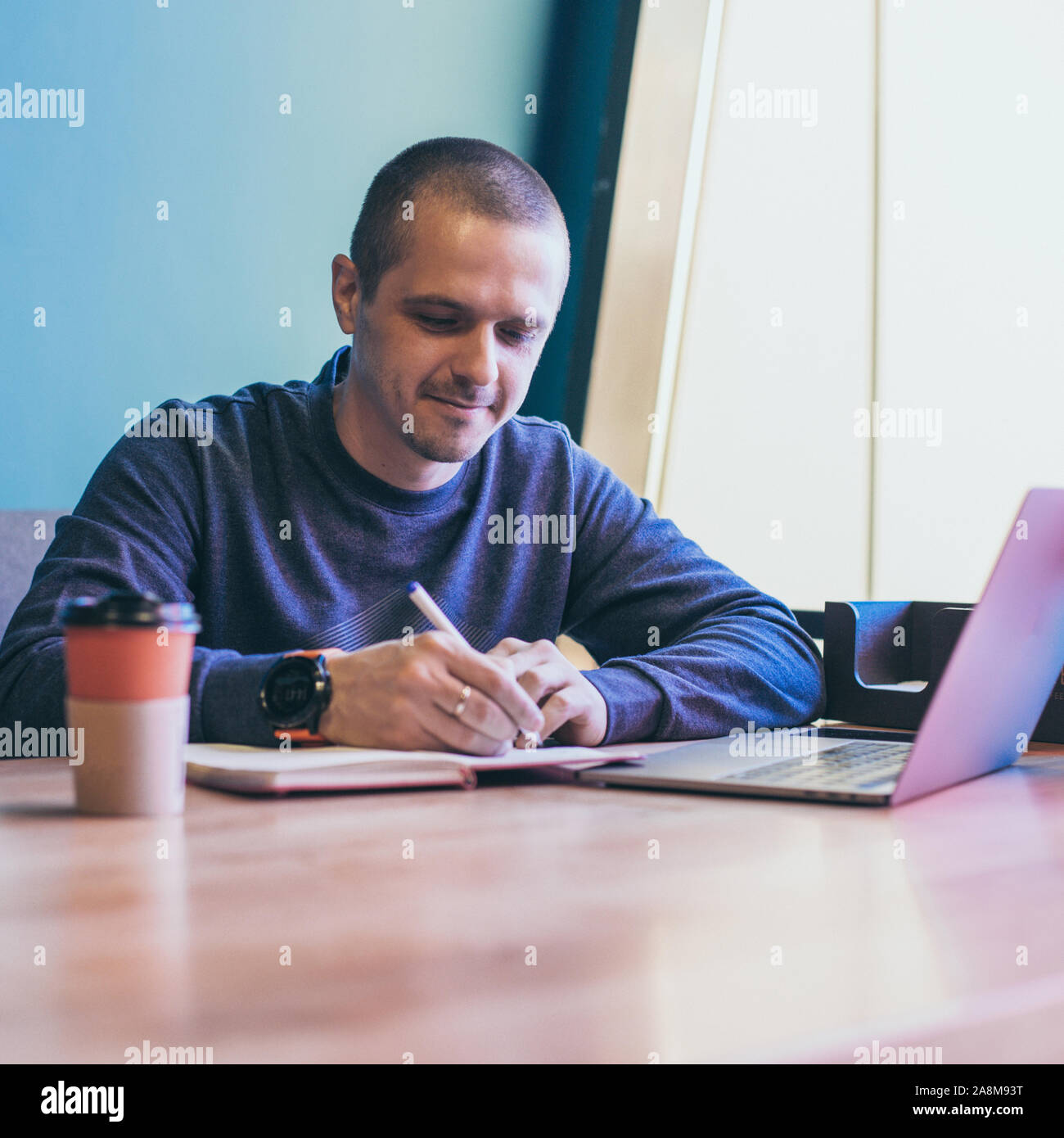 Man working in cozy coworking or cafe Stock Photo