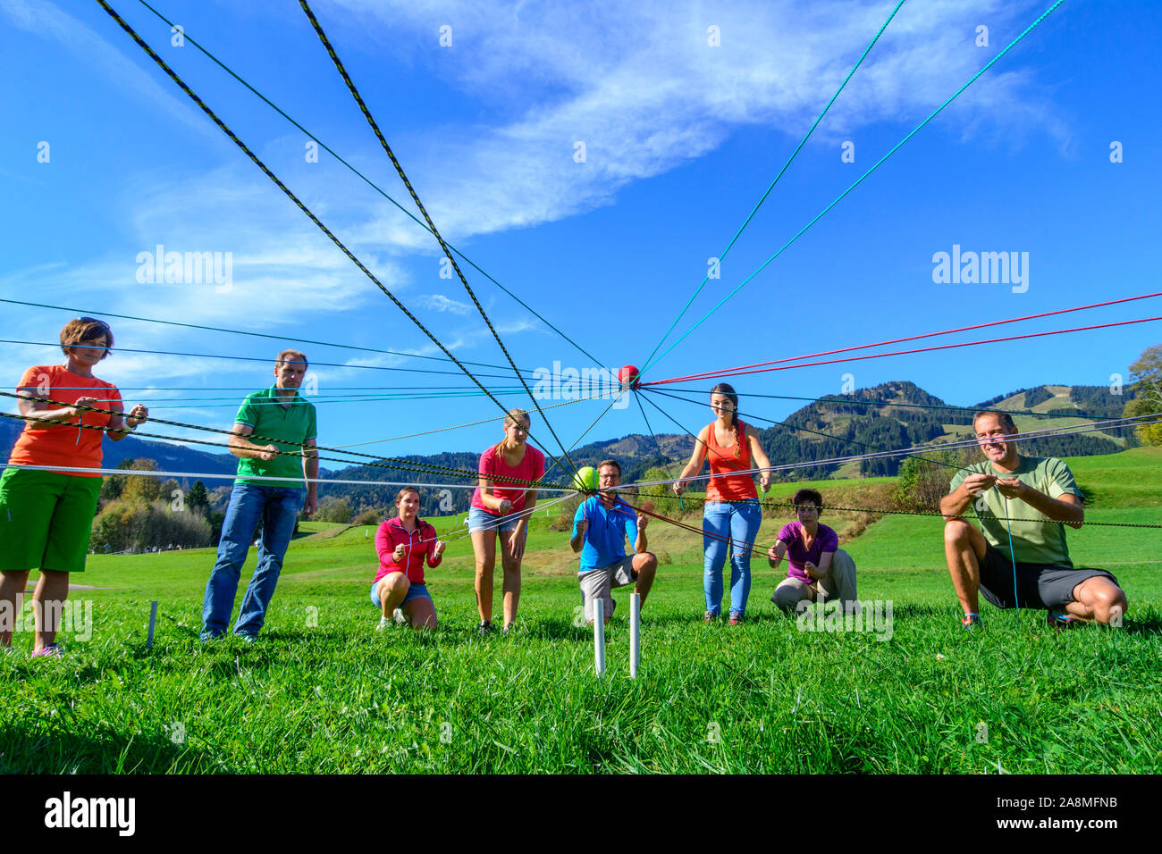 Teambuilding exercise called ball transport complex Stock Photo Alamy
