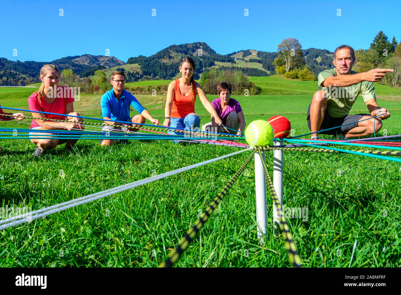 Teambuilding exercise called ball transport complex Stock Photo Alamy