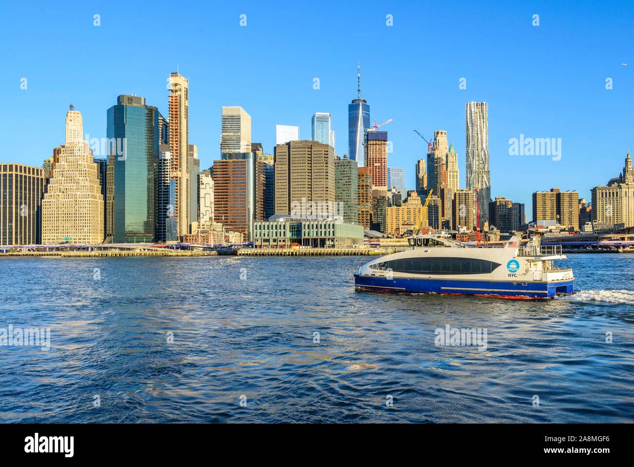 Ferry, NYC Ferry on the East River, view from Pier 1 to the skyline of
