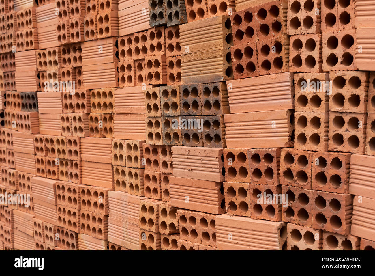 Red Clay or Terracotta bricks stacked neatly on a building site Stock