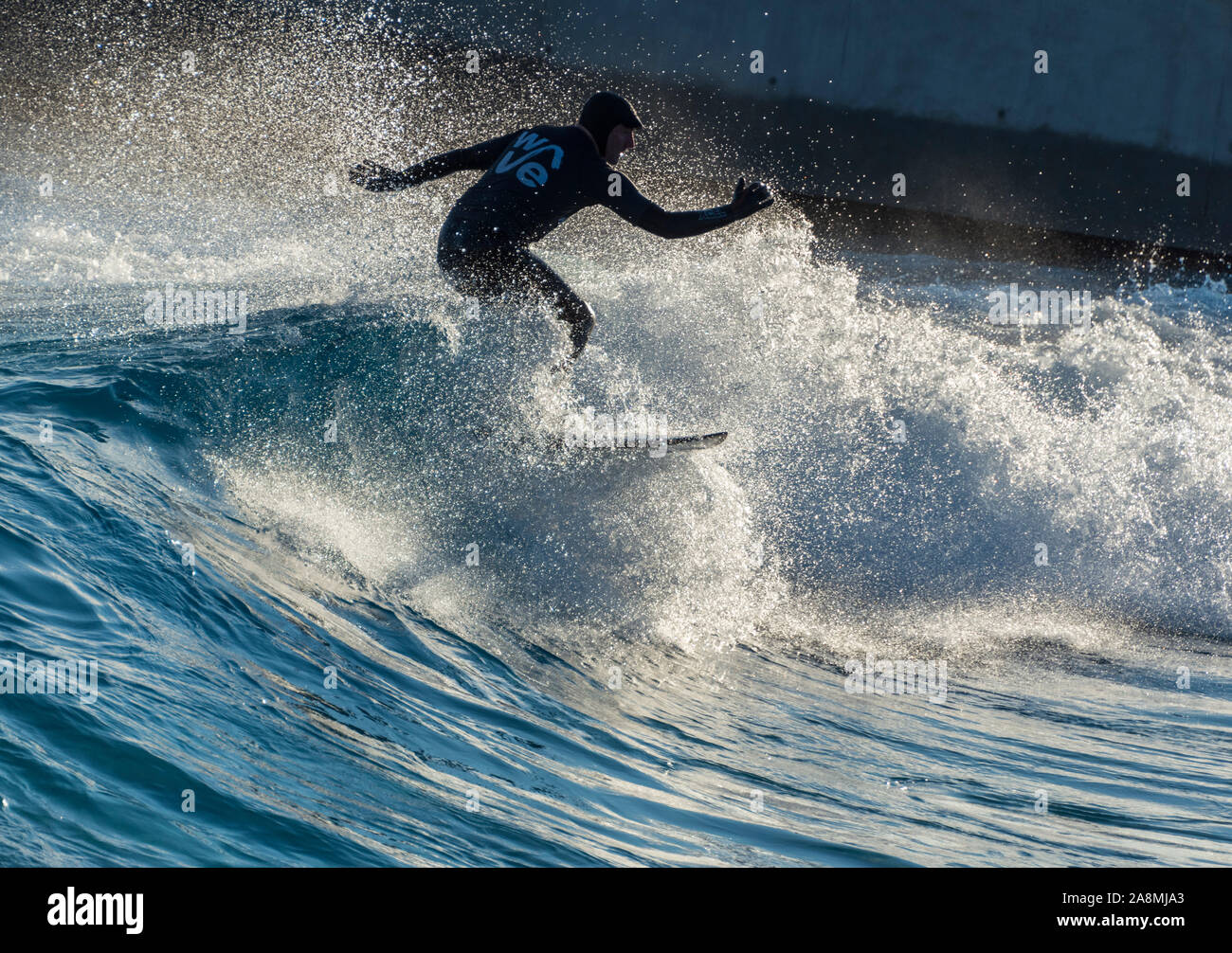 Surfer riding advanced level waves at The wave, Bristol, an artificial inland surfing lake near