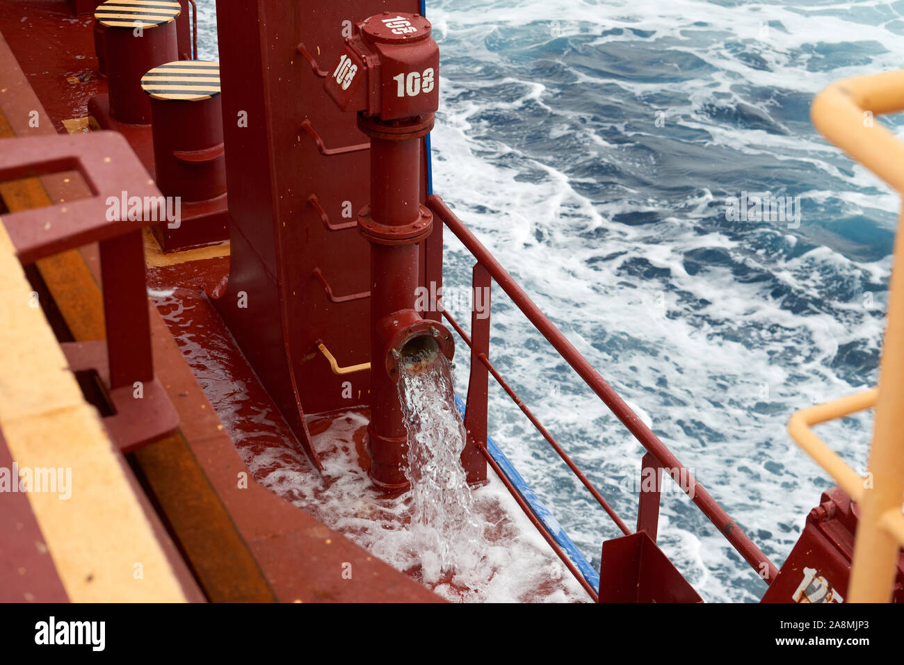 View of ballast water exchange process onboard of a ship using flow-through method underway in open ocean. Overflow method through ballast tank air he Stock Photo