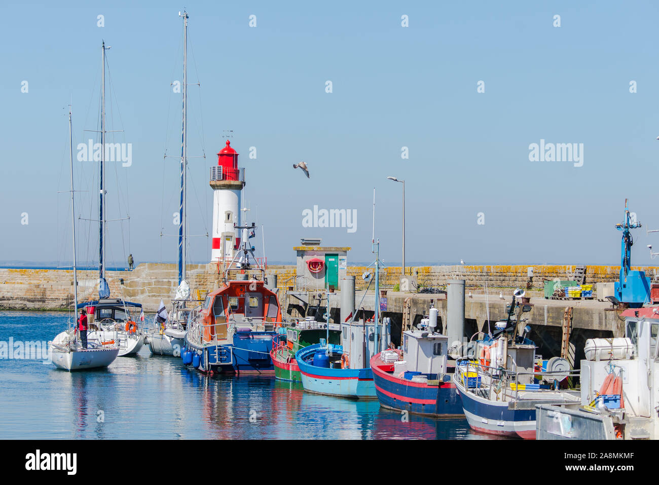 Brittany, ile de Groix, harbor Port-Tudy, red lighthouse and boats Stock Photo