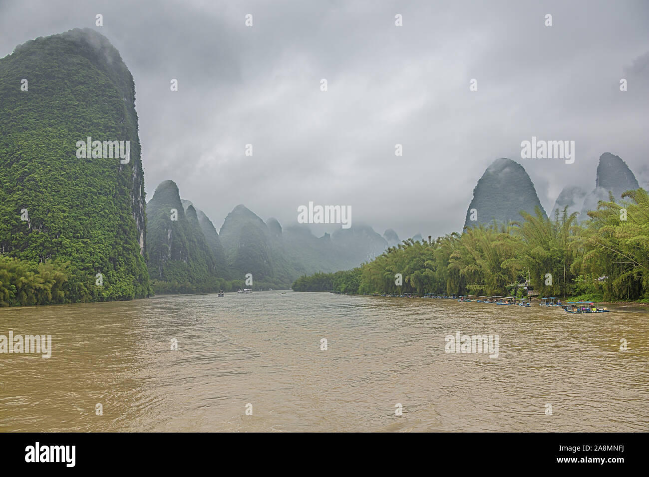 Editorial: GUILIN, GUANGXI, CHINA, April 19, 2019 - Passing Xingpingzhen fishing village on the Li River in the vicinity of Yangshuo near Guilin Stock Photo