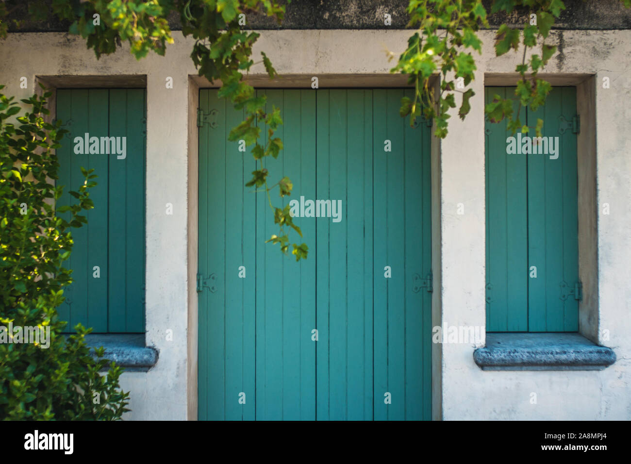 Closed wooden shutters on the windows and doors of the Mediterranean authentic home Stock Photo