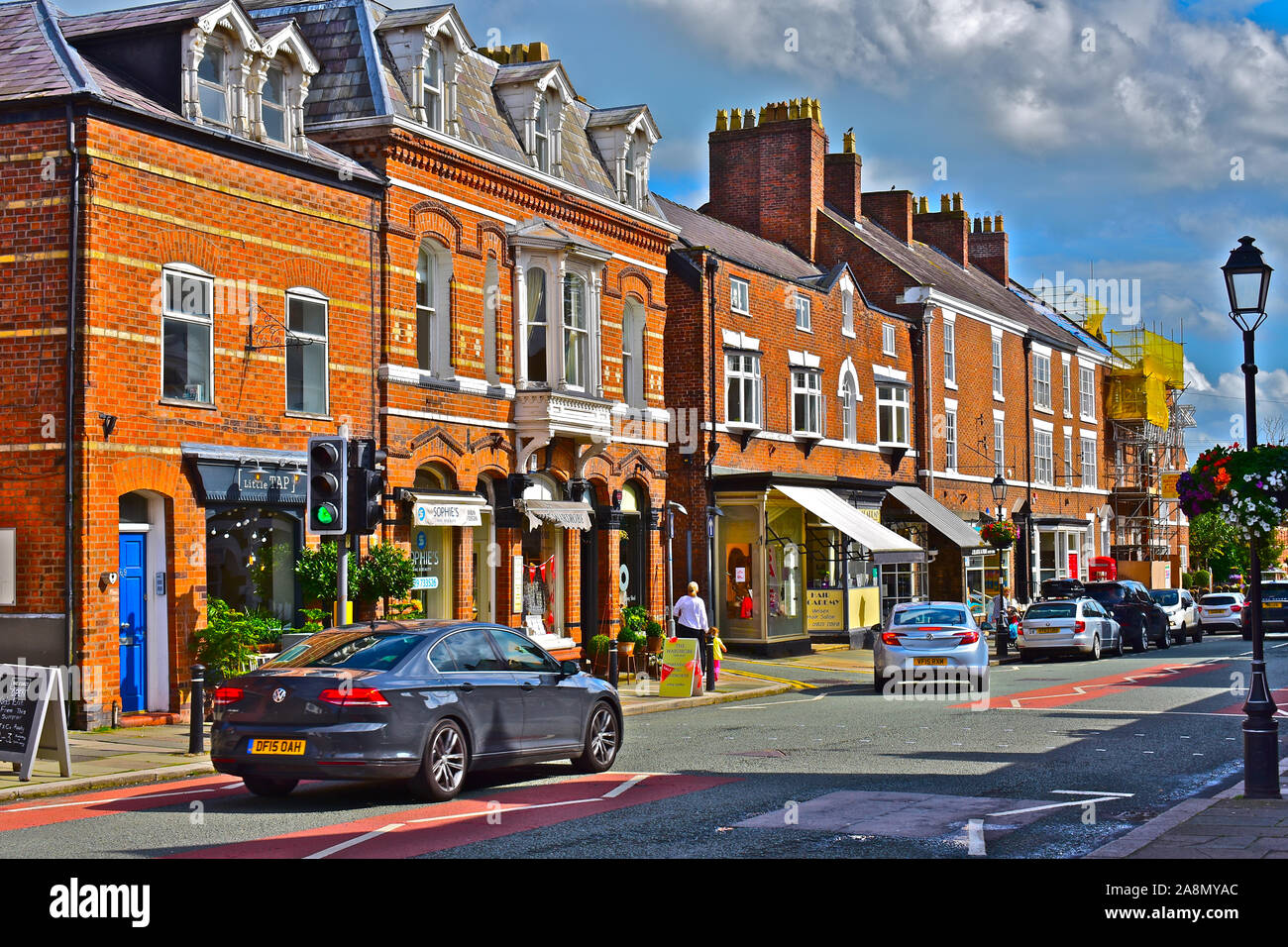 A typical row of red brick buildings in the centre of the quaint rural village of Tarporley. High Street shops mainly small local businesses. Stock Photo