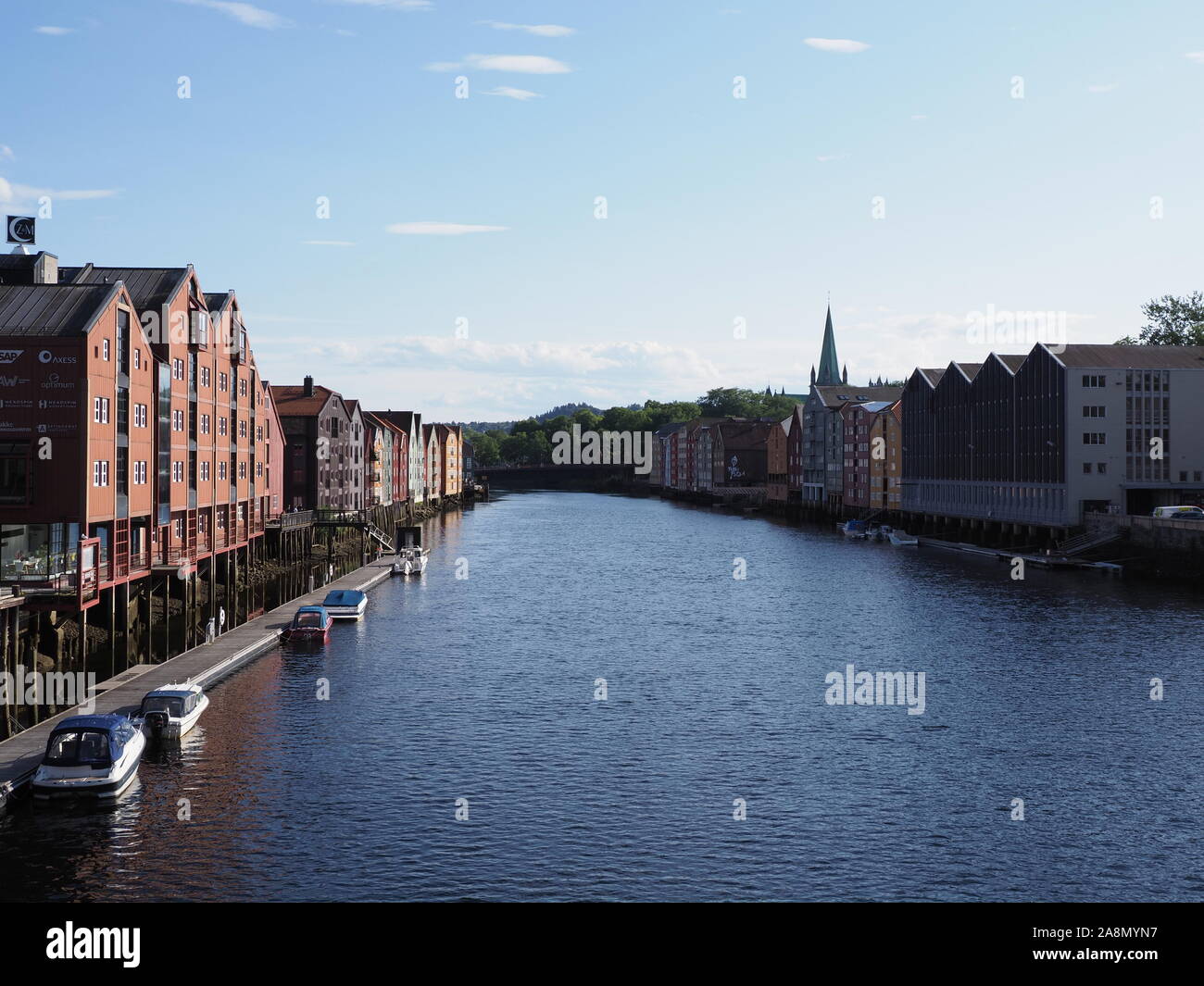 TRONDHEIM, NORWAY on JULY 2019: Canal and colored houses at Nidelva river at Trondelag district in european Nidaros city with clear blue sky in warm s Stock Photo