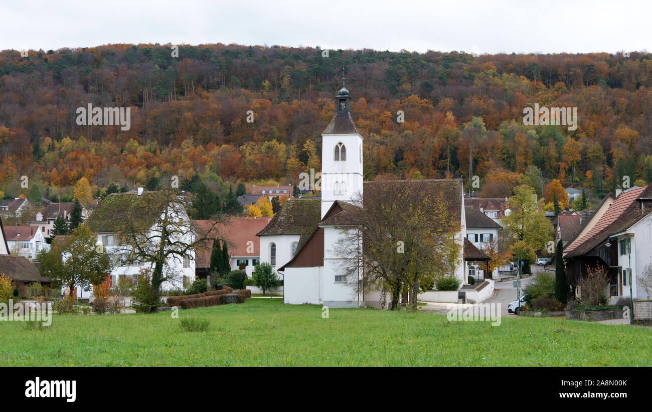 Small village in western Switzerland surrounded by autumn forest Stock Photo