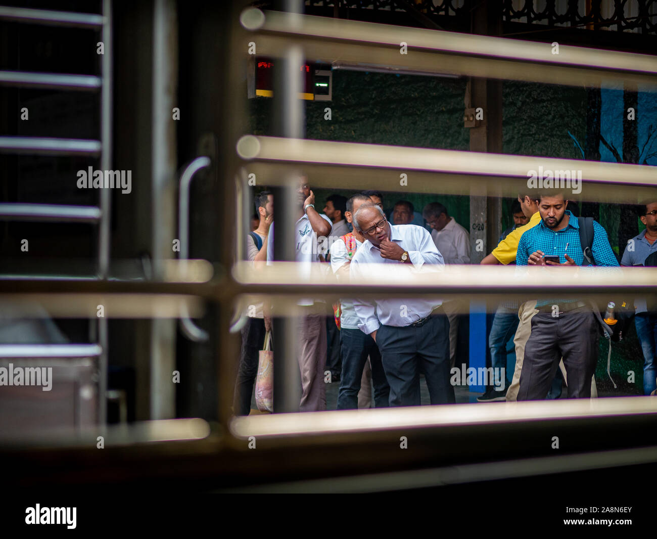 Mumbai, India - October 28,2019 : Unidentified passengers waiting at railway station for Mumbai local train Stock Photo