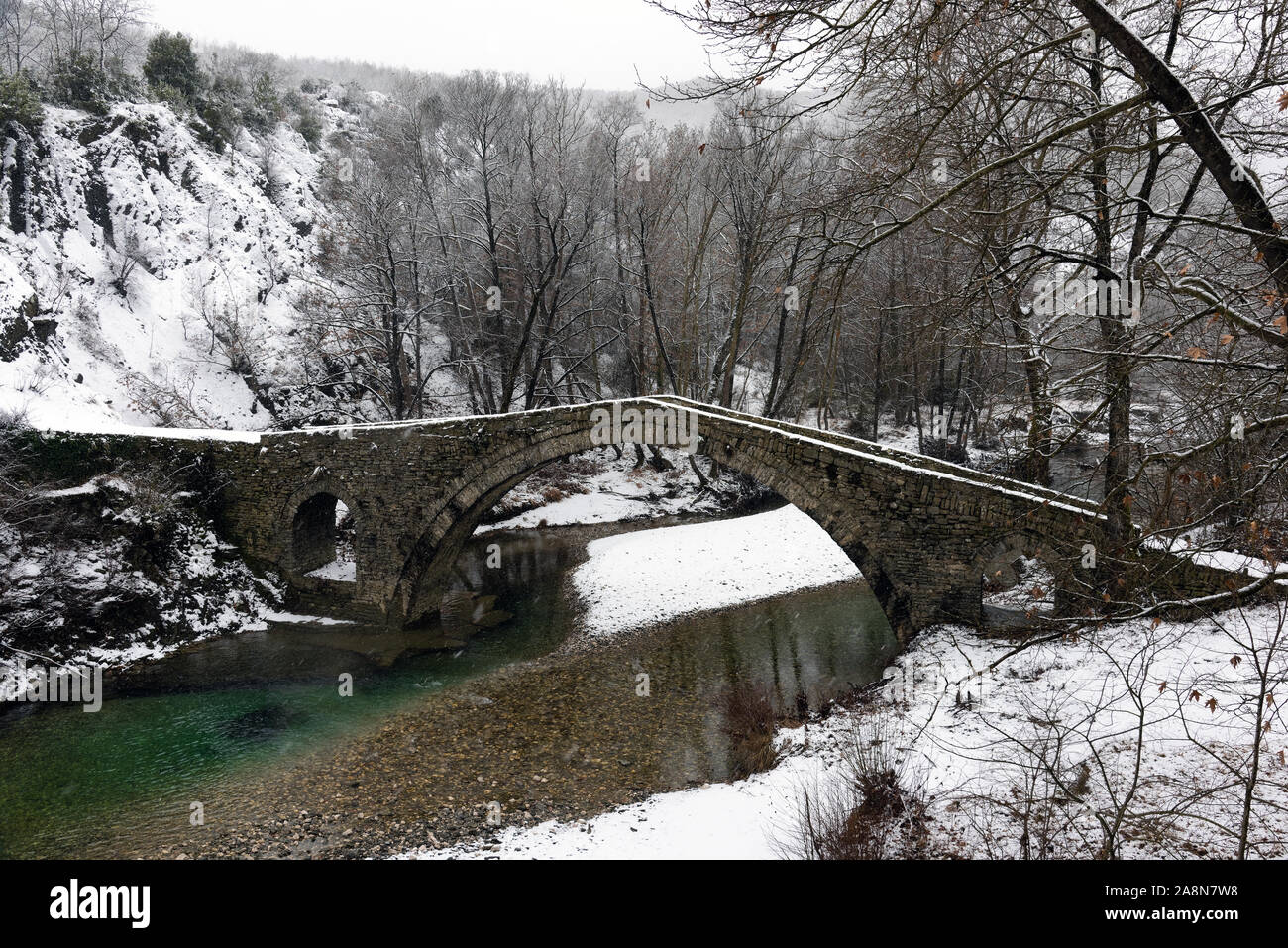 View of the traditional stone Bridge of Kamber Agas in Epirus, Greece in winter Stock Photo