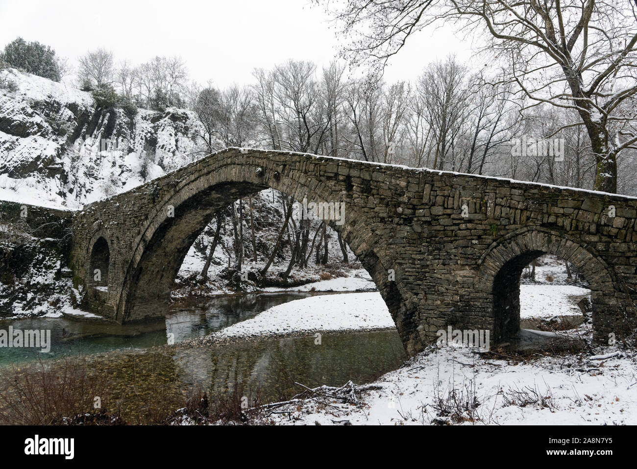 View of the traditional stone Bridge of Kamber Agas in Epirus, Greece in winter Stock Photo