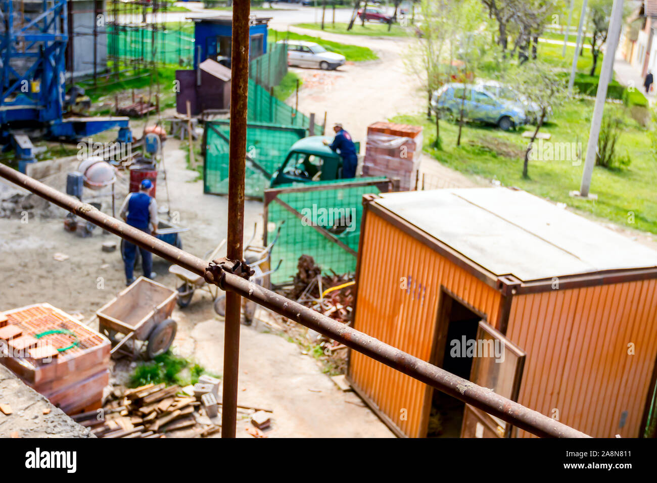 Rusty scaffold is placed against edifice, building under construction ...