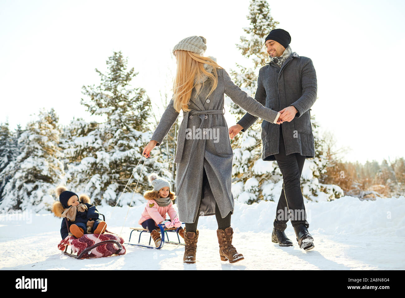 Happy family sledding in the park in winter Stock Photo - Alamy