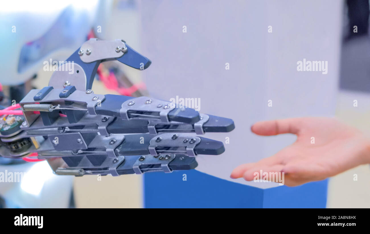 Woman and robot hands Stock Photo