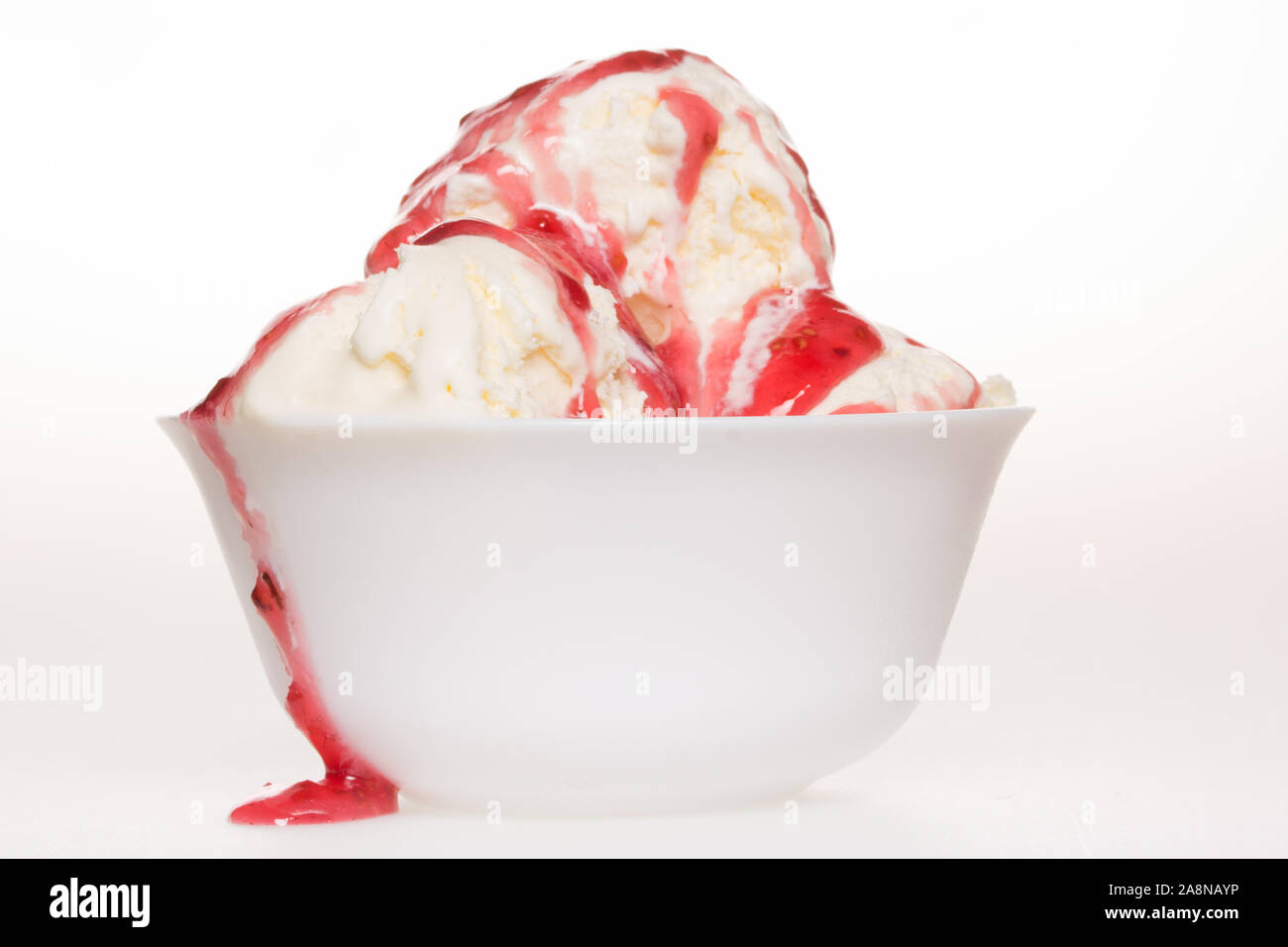 Vanilla ice cream with raspberry syrup on white Stock Photo - Alamy
