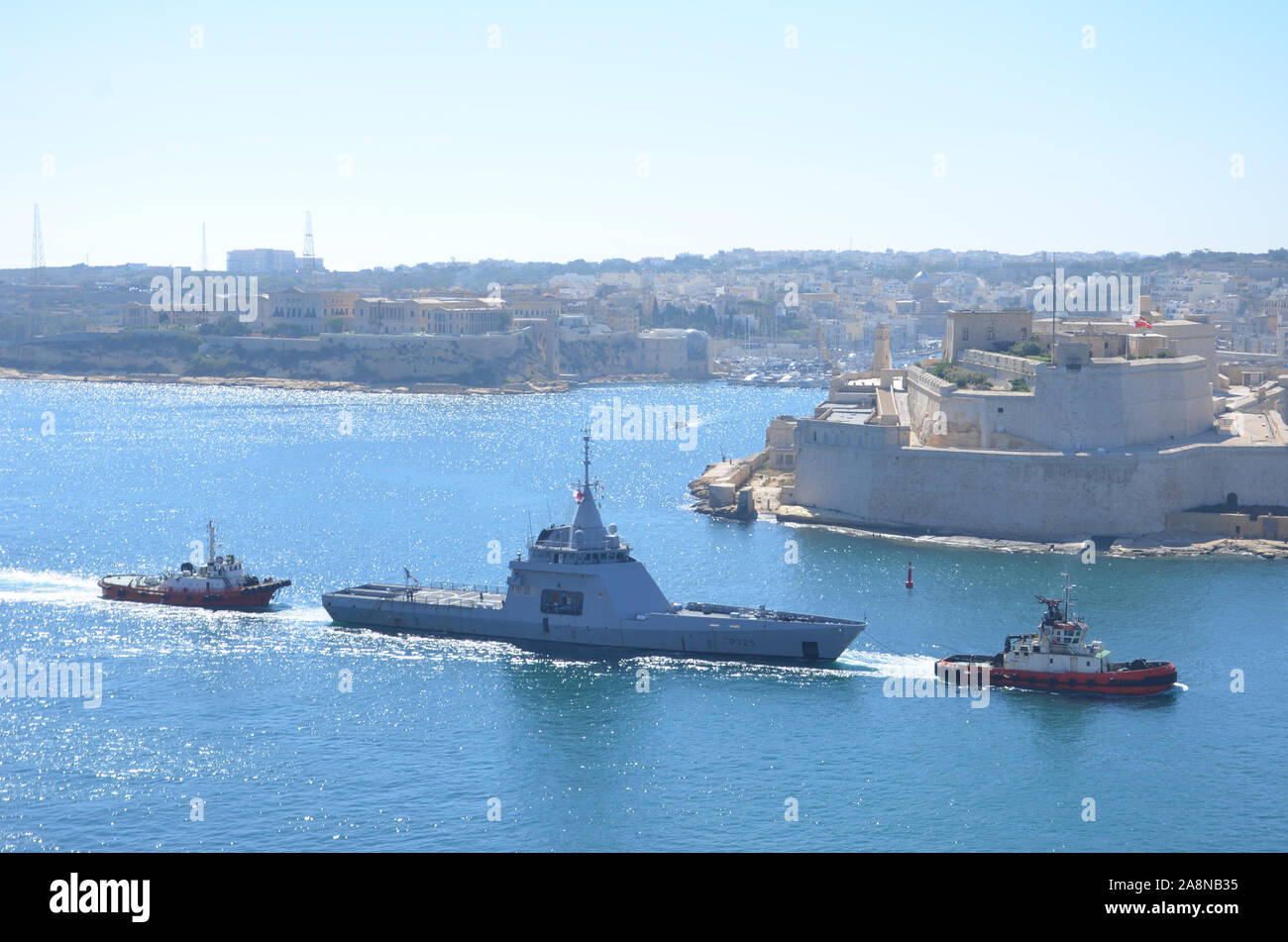 Warship and Tug Boats in the Grand Harbour, Malta Stock Photo