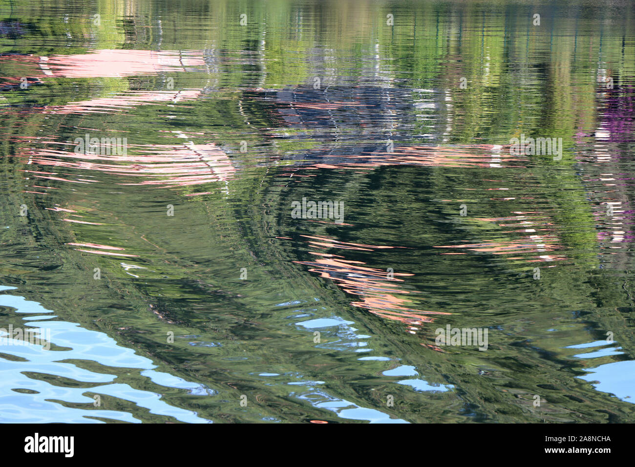 Reflection of the coast on the surface of the water as background Stock Photo