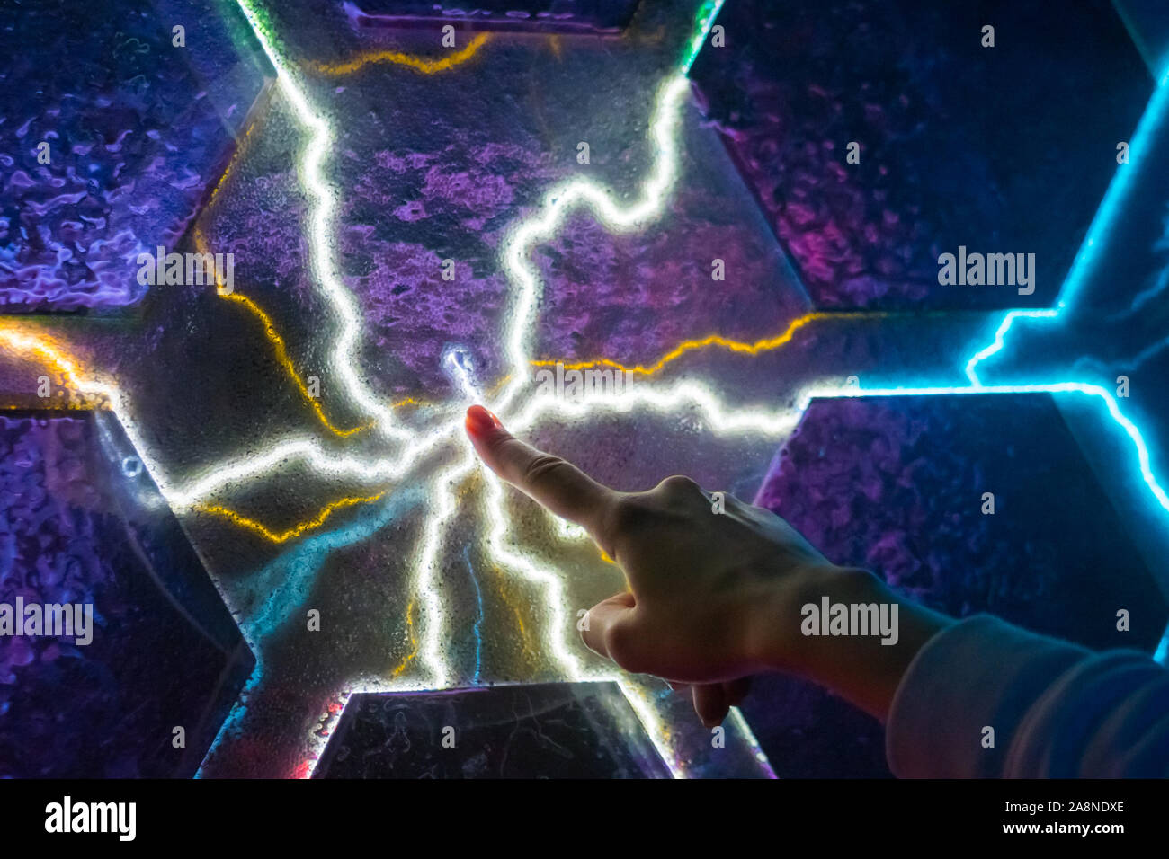 Woman touching plasma panel display Stock Photo