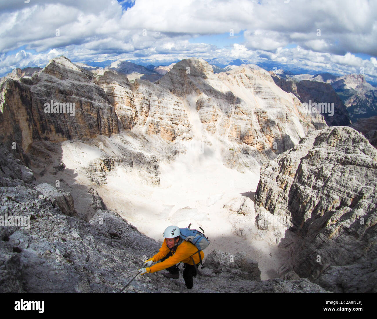An attractive mountain climber on a steep and hard Via Ferrata climb in the Italian Dolomites Stock Photo
