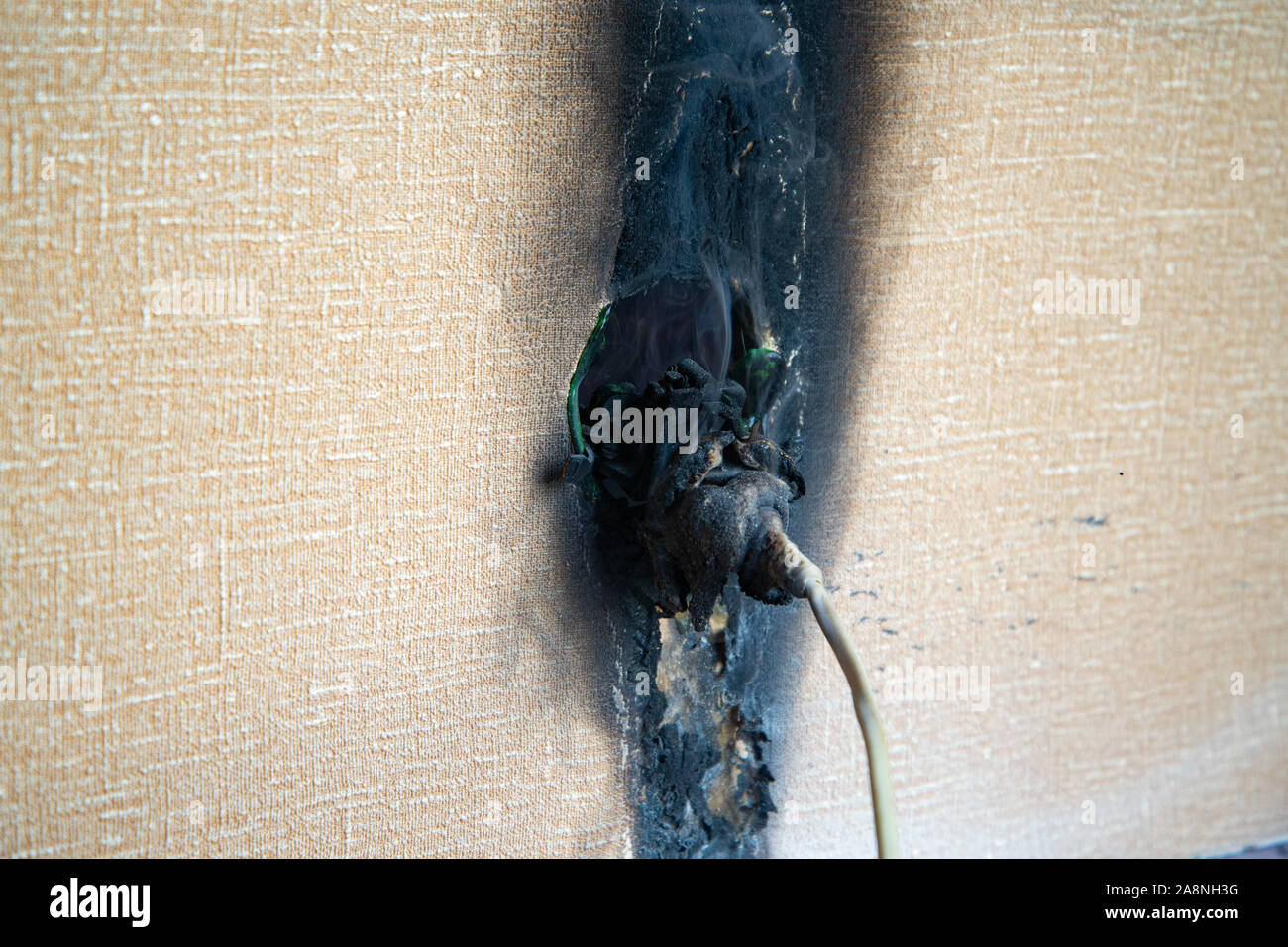 Plastic power socket fused and burned out after a fire in the apartment