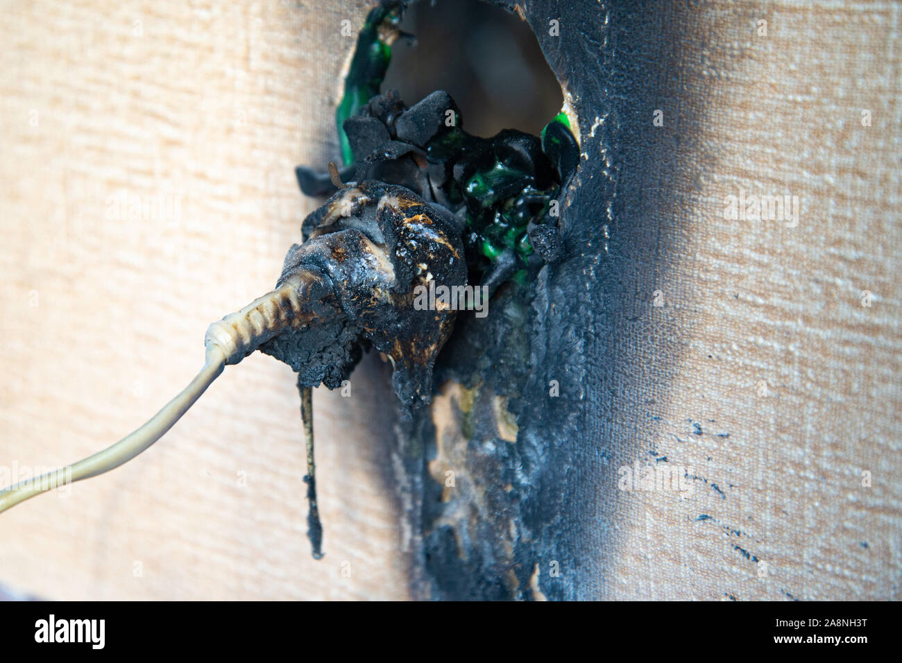 Plastic power socket fused and burned out after a fire in the apartment