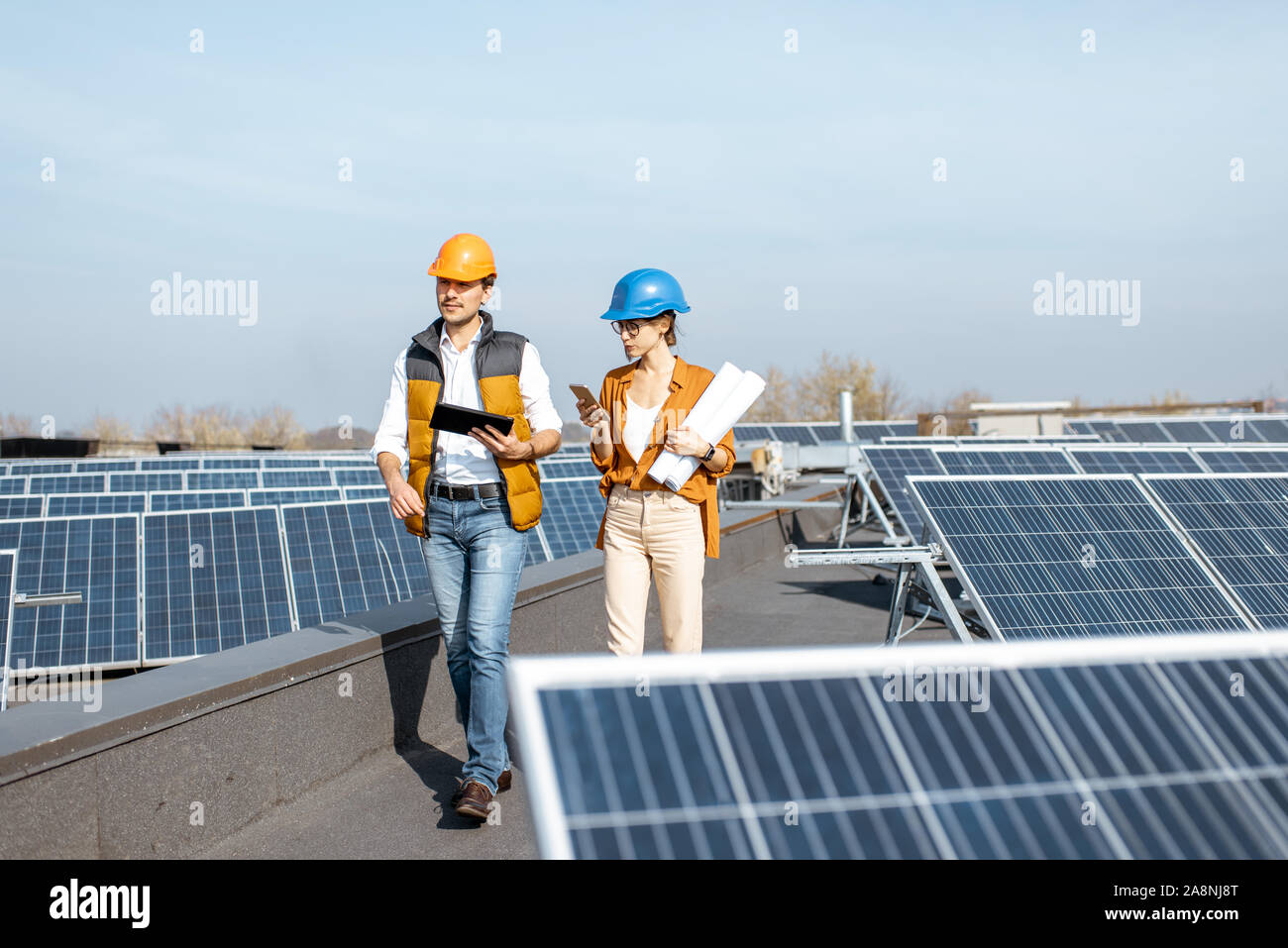 Two engineers or architects examining the construction of a solar power ...