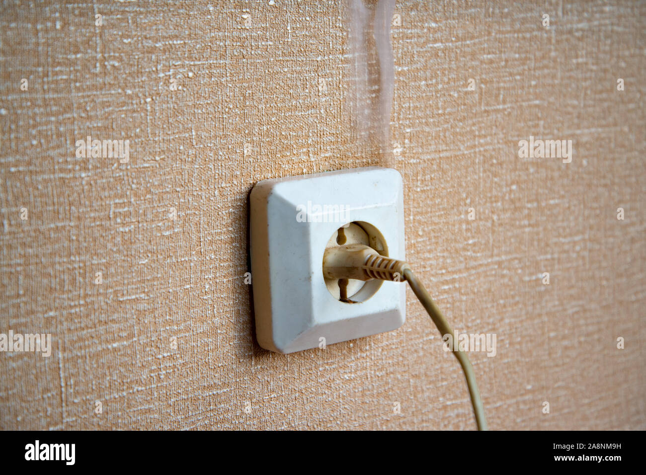 The power outlet starts to light up. Defective wiring causes a fire