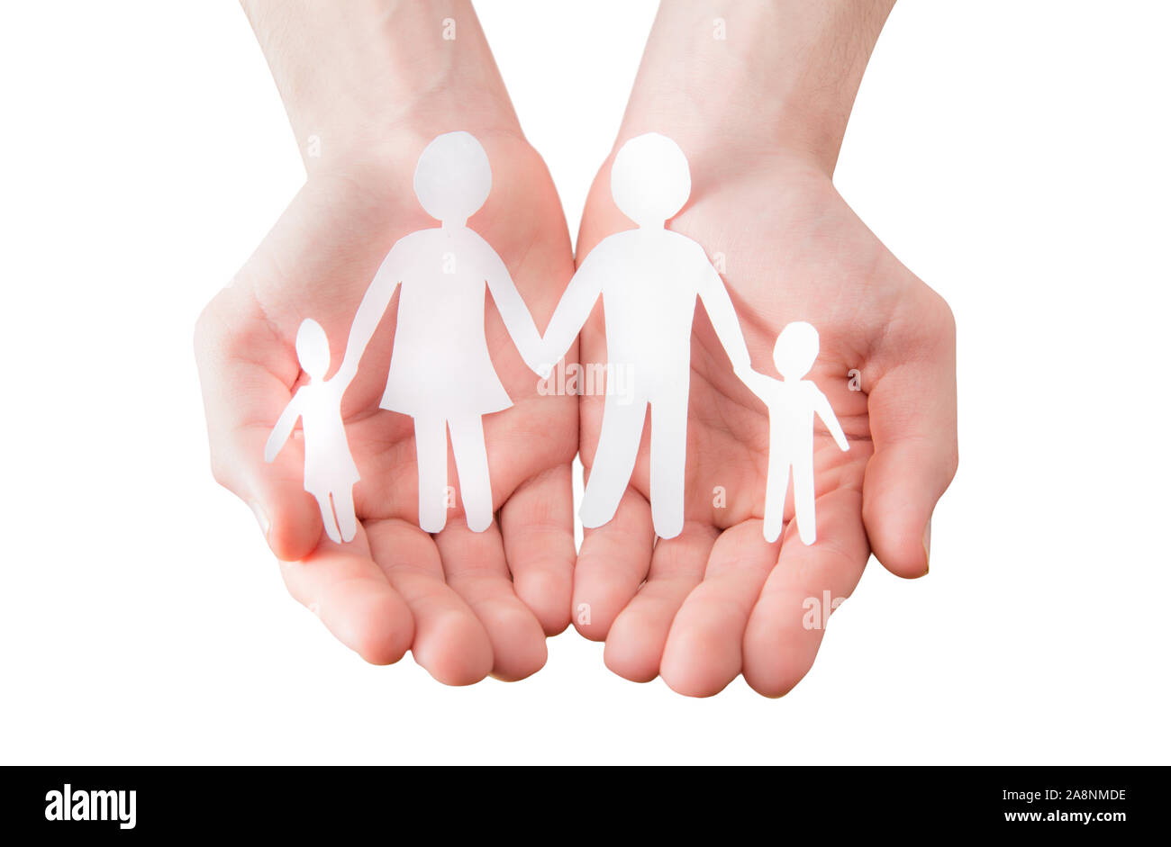 hands holding a paper cutout in the form of a family Stock Photo