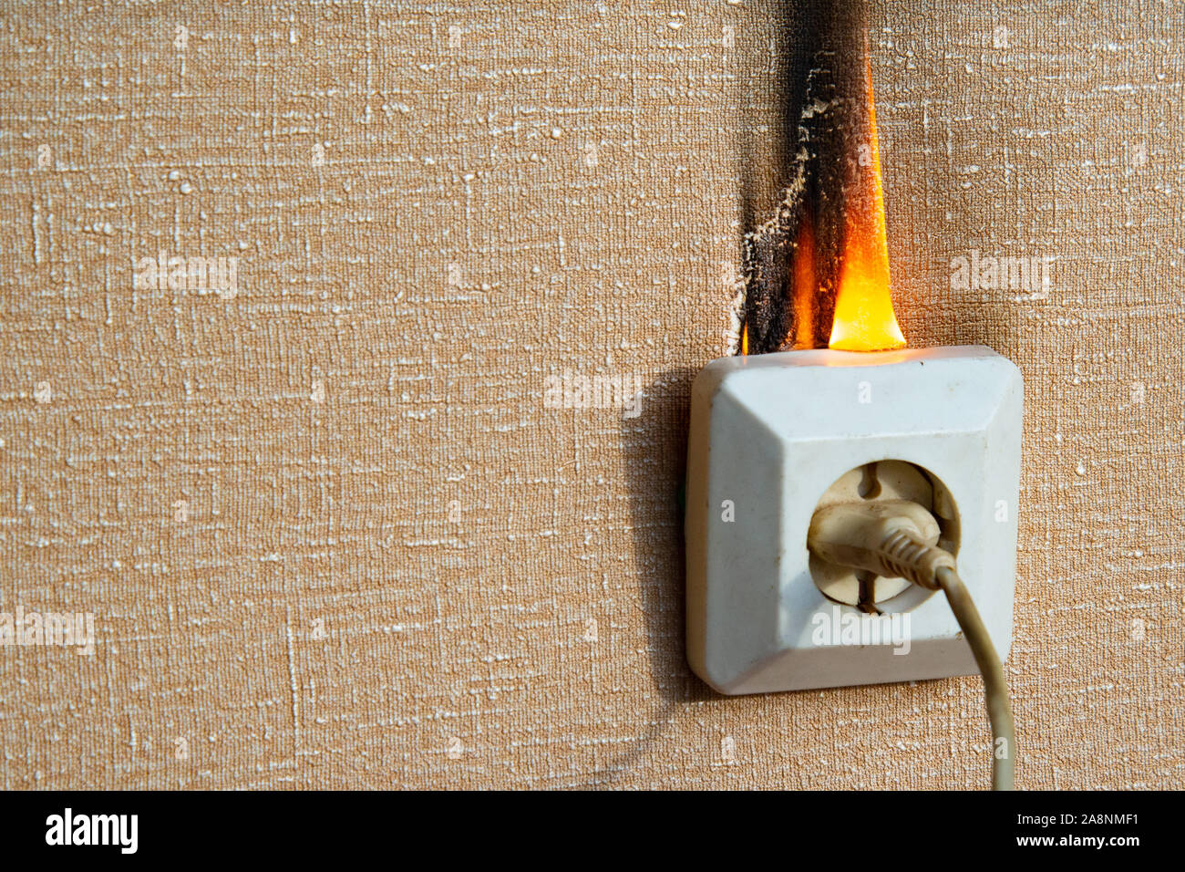 Defective wiring causes a fire. An old, worn out socket requiring