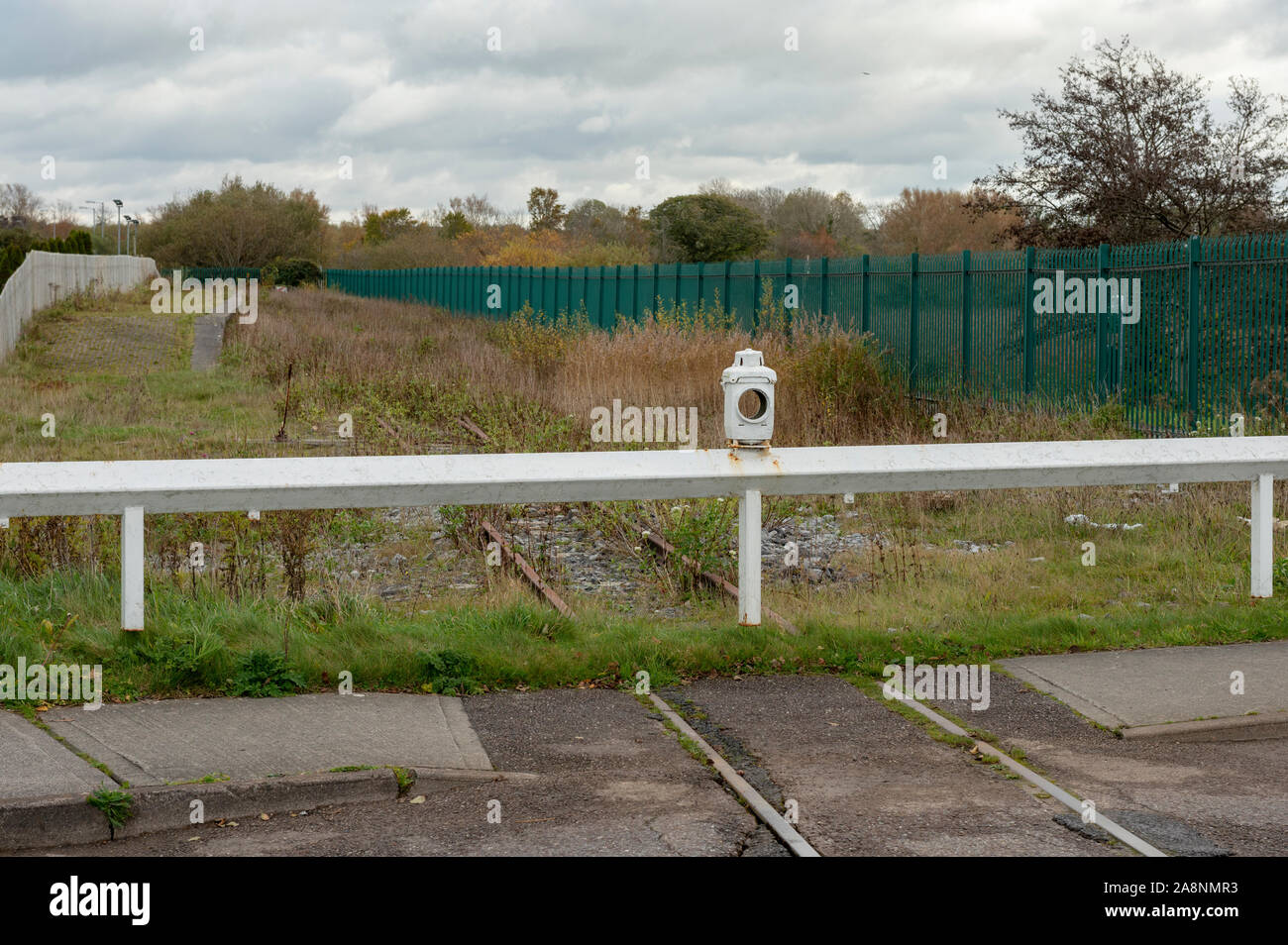 Derelict abandoned railway or railroad and barrier at the Ballymullen walking trail entrance in Tralee, Ireland Stock Photo