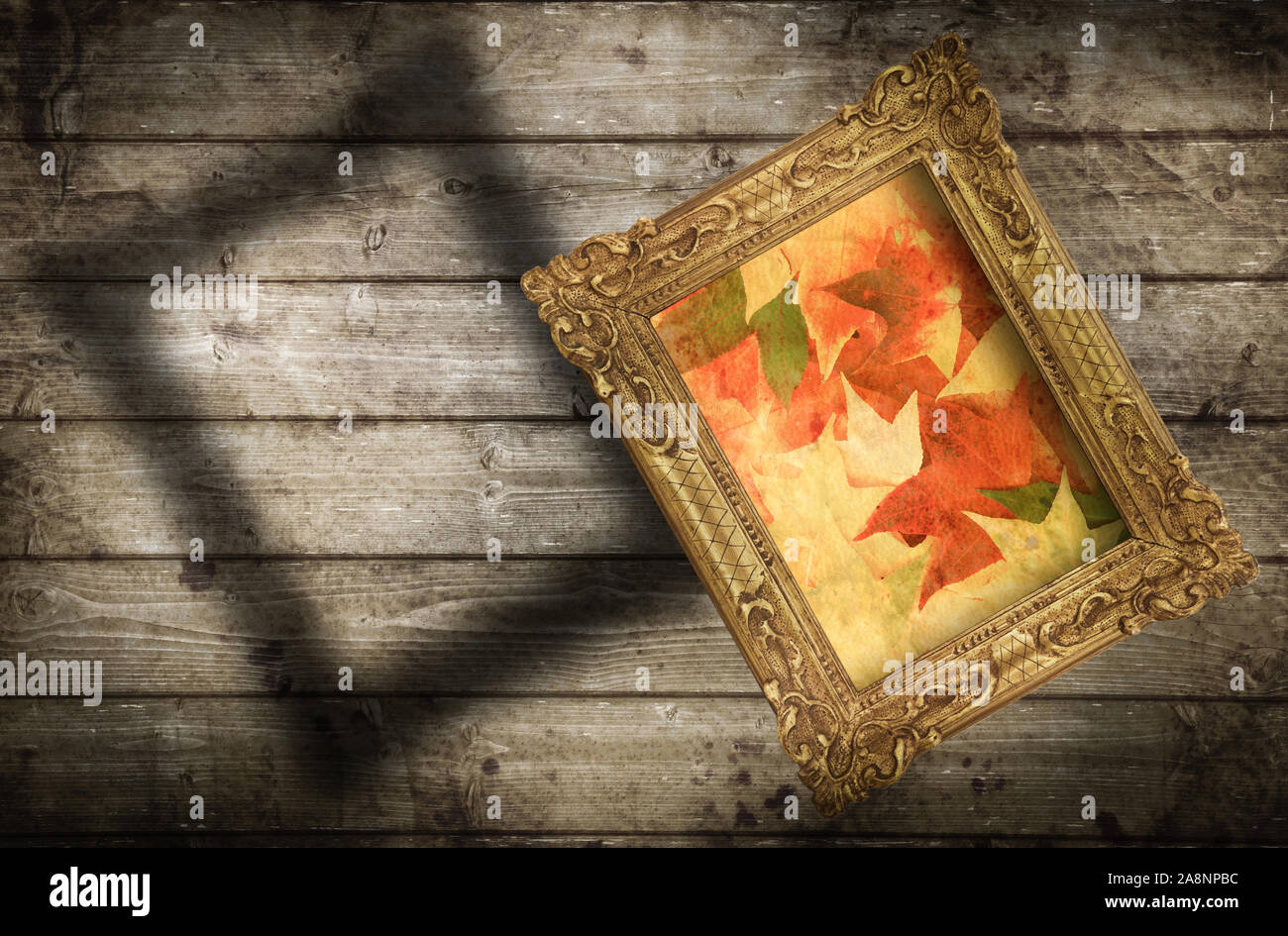 Old frame hanging on wooden wall Stock Photo - Alamy