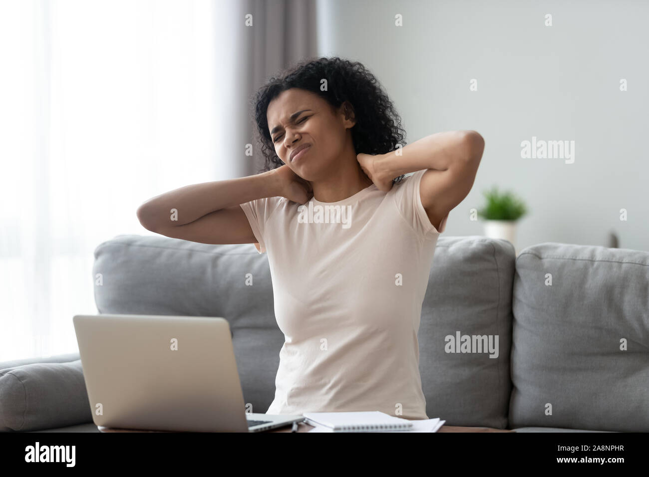 Woman massaging neck hi-res stock photography and images - Alamy