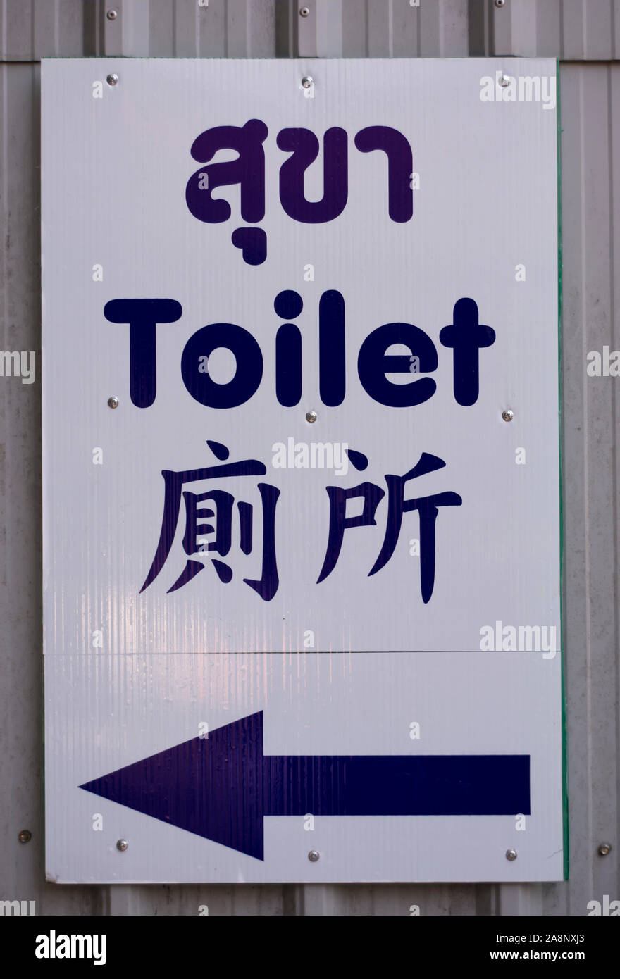 toilet sign written in thai, english and chinese, at the temple of wat phra that doi suthep, chiang mai, thailand Stock Photo