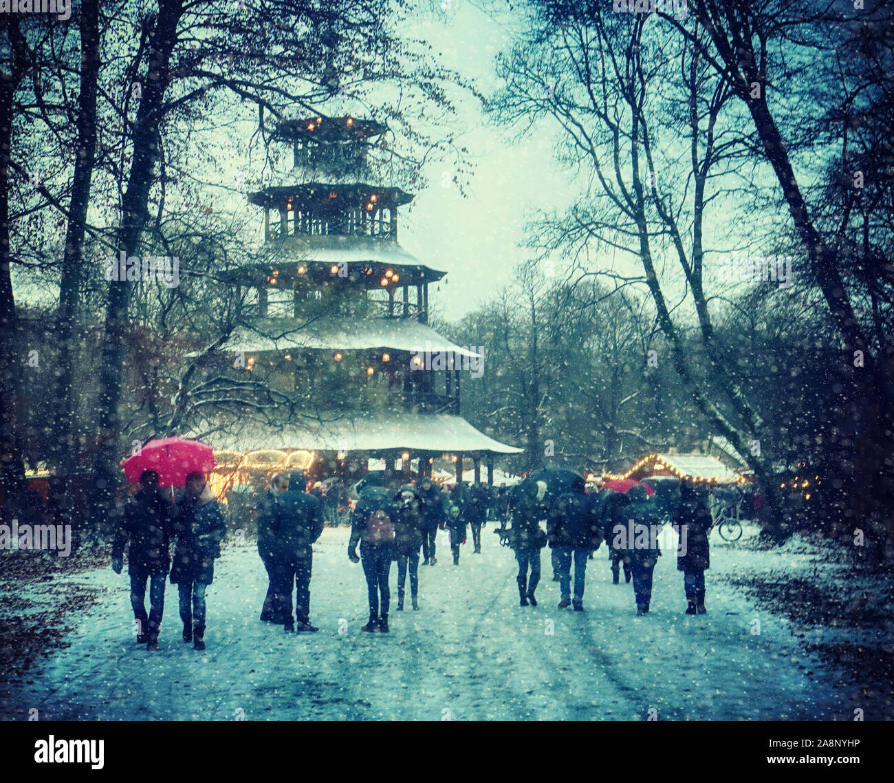 Munich, Germany - Christmas market at Chinese Tower in Englischer Garten and snowfall Stock Photo