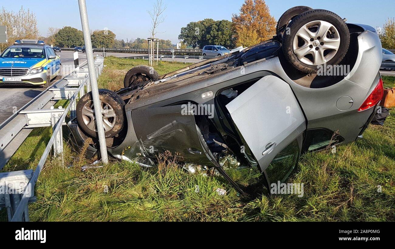 Cappeln, Germany. 10th Nov, 2019. After a rollover, a car is on a guardrail  next to the Autobahn 1 (A1). An 83-year-old female car driver passed out at  the wheel on the