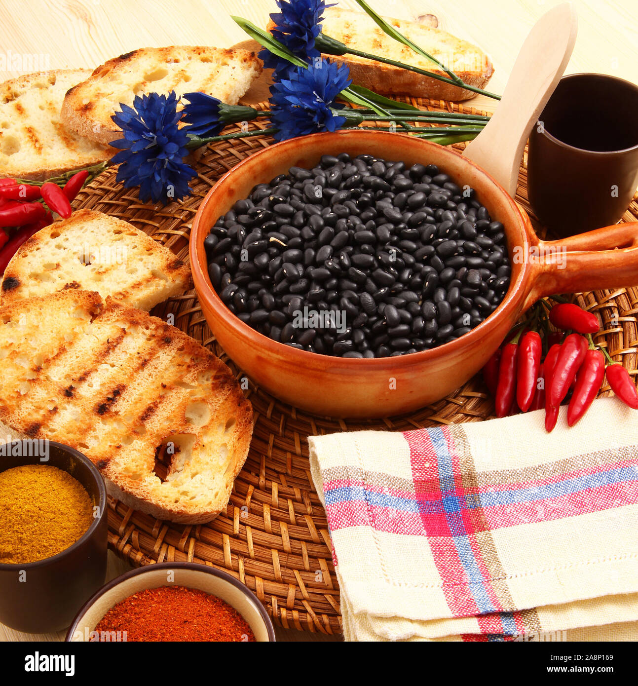 dry legumes in rustic dish on wooden table Stock Photo