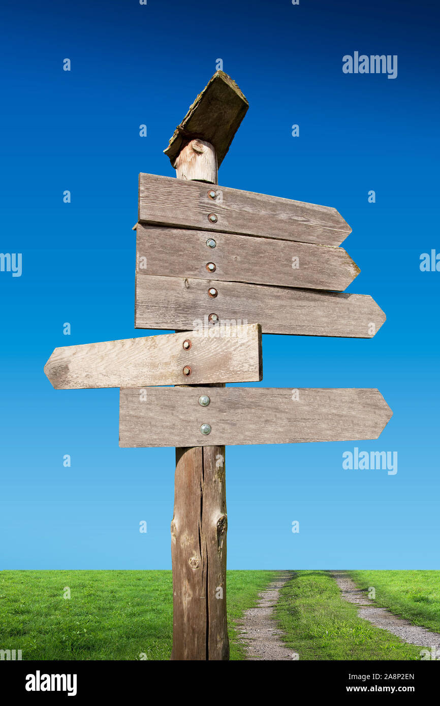 directional wooden arrows on nature background Stock Photo - Alamy