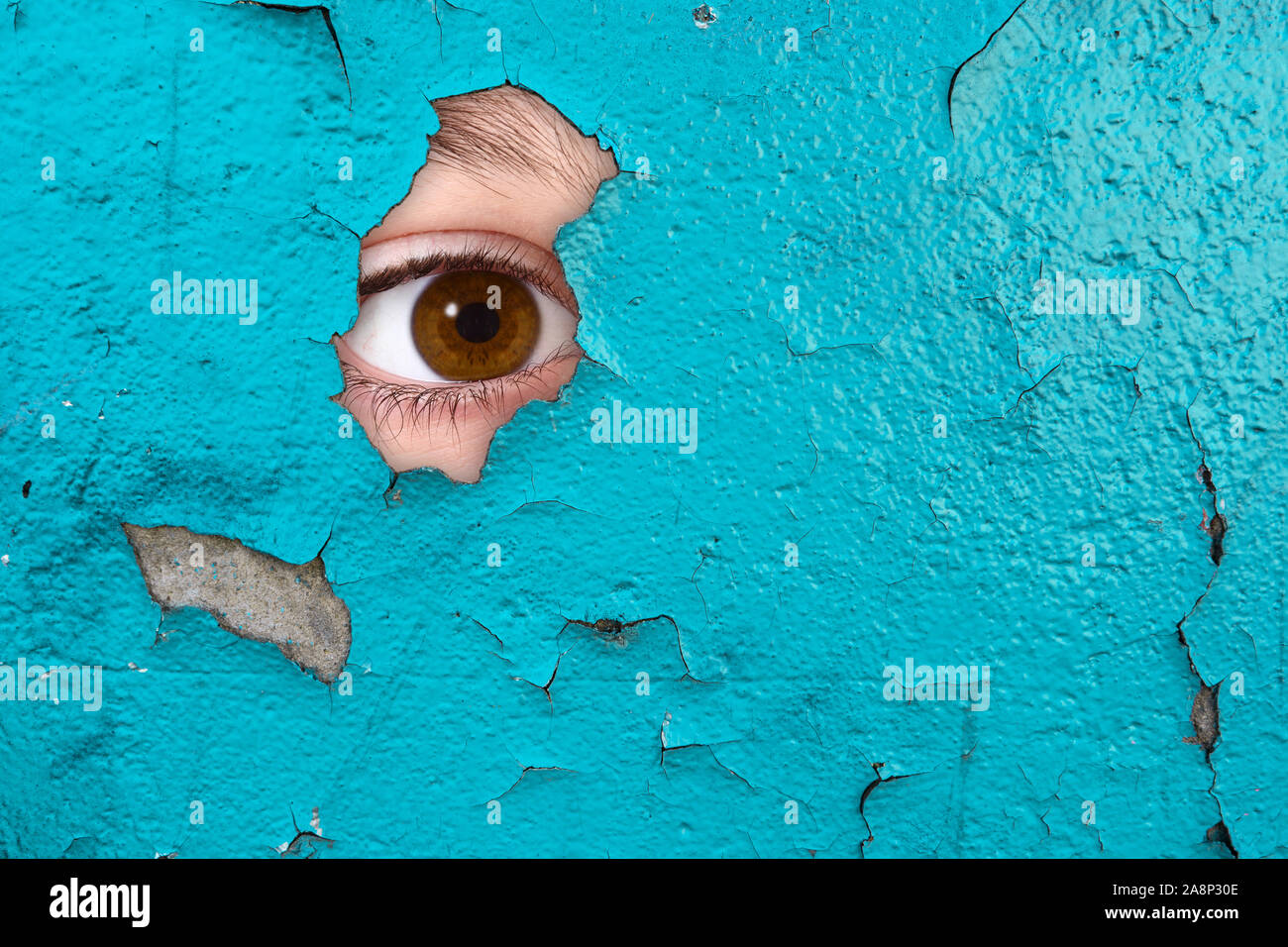 an Eye spying through a wall Stock Photo Alamy