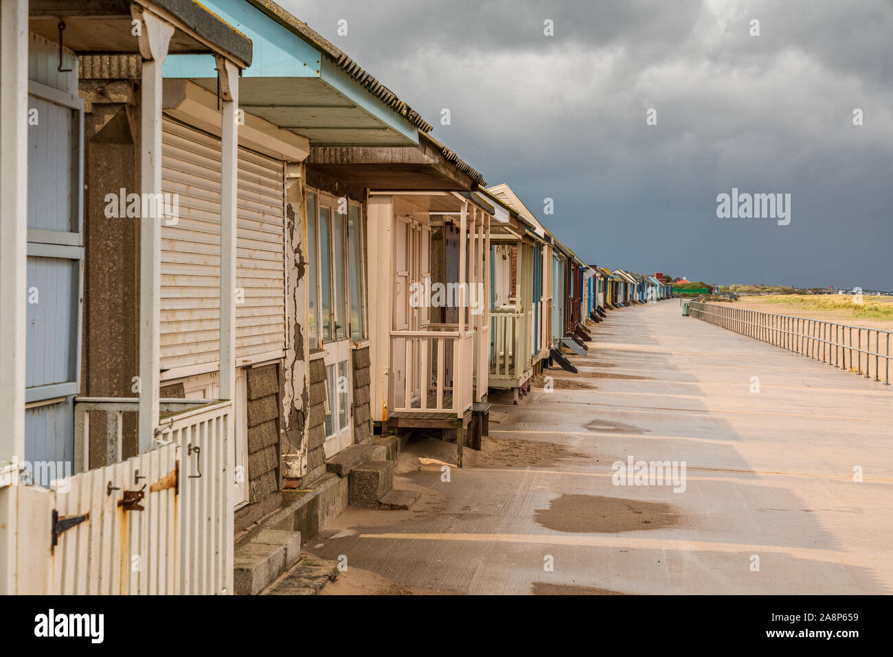 Grey clouds over the Beach Huts in Sandilands, Lincolnshire, England, UK Stock Photo